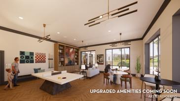 The clubhouse game room at Waterstone at Big Creek features both a pool table and a shuffleboard table, providing a fun and engaging space for residents to unwind and enjoy leisure activities.